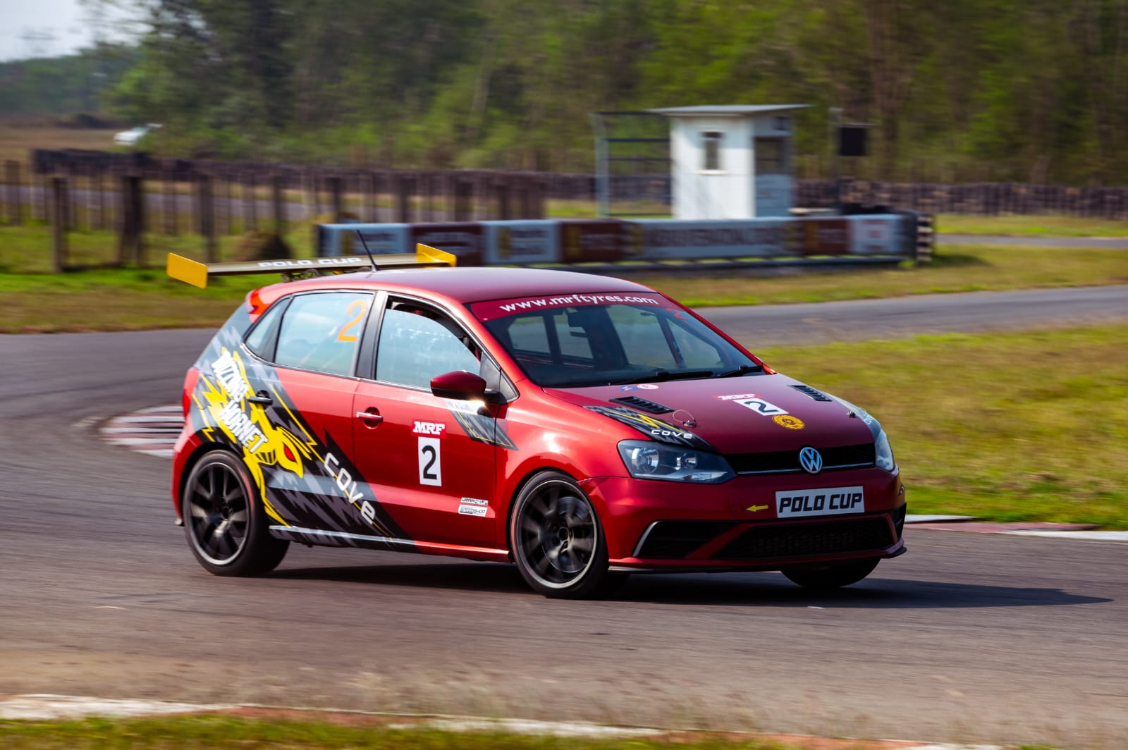 Avi's red Polo Cup car at speed through a corner
